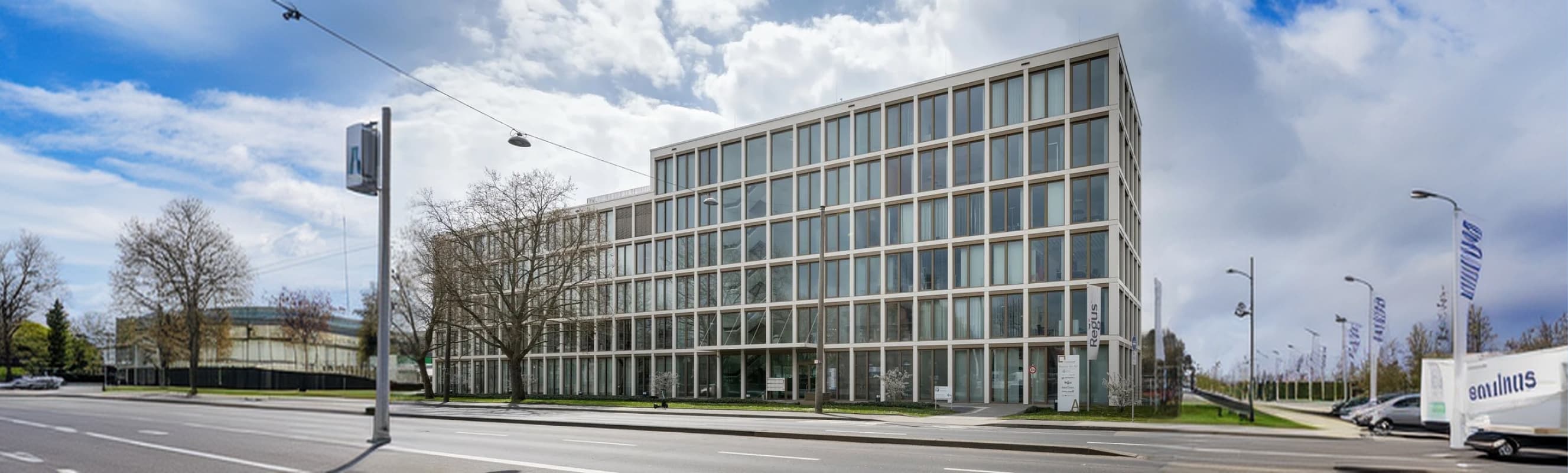 The modern exterior storefront and signage of the new Travod corporate office located in Wiesbaden, Germany.